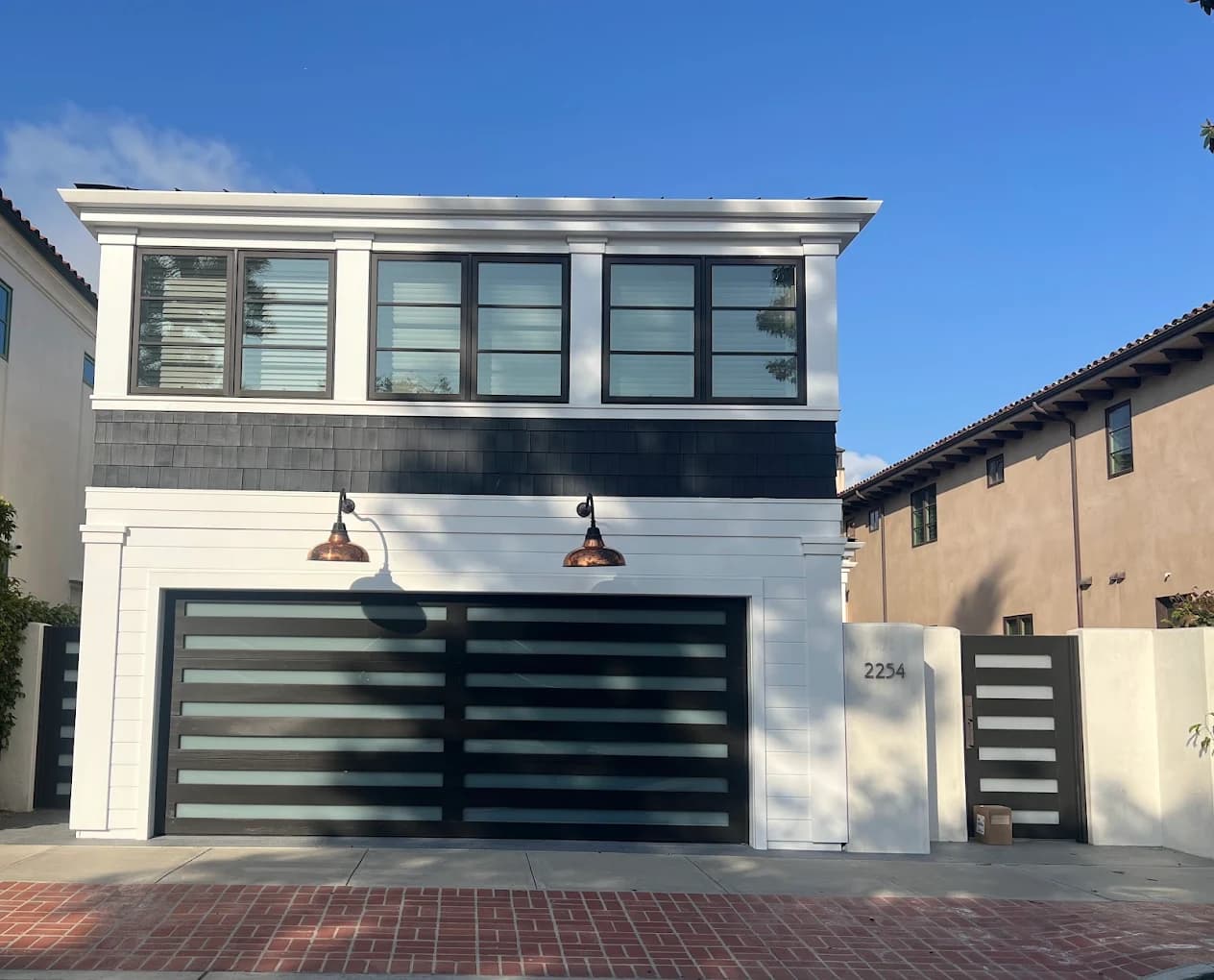 Modern glass-panel garage door with a dark frame in Folsom